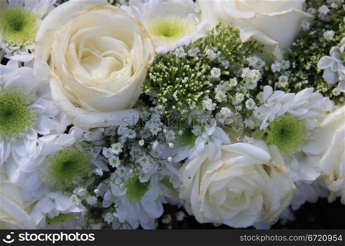 Detail of a white bridal bouquet: roses, gypsophila and mums