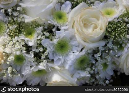 Detail of a white bridal bouquet: roses, gypsophila and mums