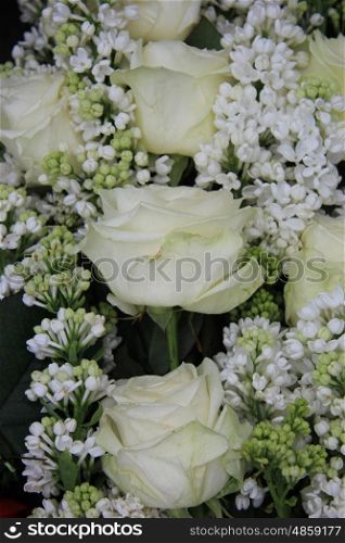 Detail of a white bridal bouquet, white roses and syringas