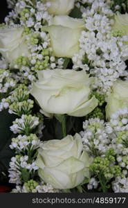 Detail of a white bridal bouquet, white roses and syringas