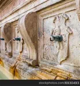 detail of an ancient fountain in Assisi (Italy)