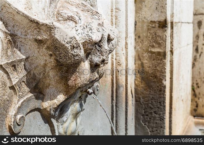 detail of an ancient fountain in Spoleto (Italy)