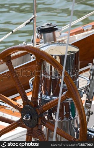 Detail of an old-fashioned boat deck with rudder and other navigation tools