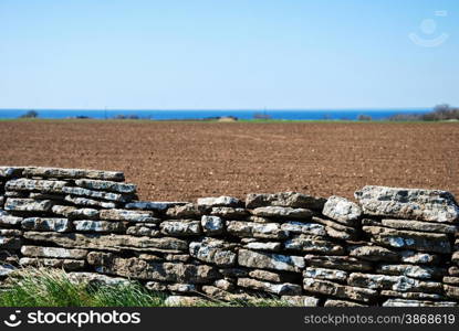 Detail of an old stone wall by a field at the island Oland in Sweden