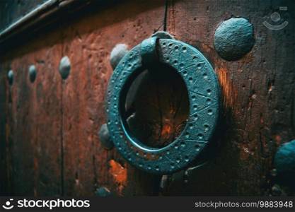 detail of an old wrought iron doorknob on a door