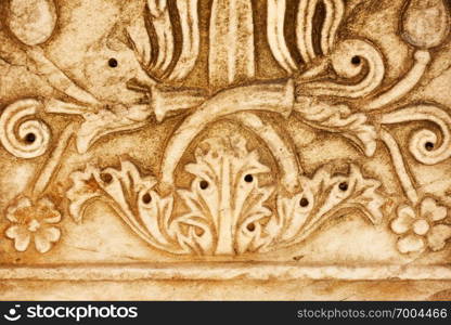 Detail of ancient greek column with floral pattern close-up