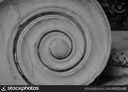 Detail of ancient greek ionic order marble column. Spiral shape black and white.