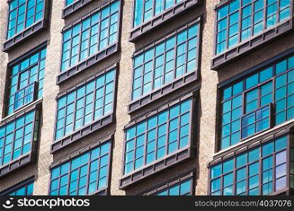 Detail of apartment windows of old industrial building, Manhattan, New York, USA