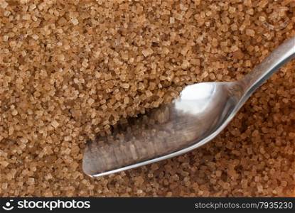 Detail of Browm sugar and spoon from sugar cane - useful as a background.