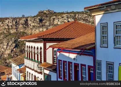 Detail of colonial style streets and houses in the old and historic city of Diamantina in Minas Gerais with the mountains in the background during the late afternoon. Detail of colonial style streets and houses in the old and historic city of Diamantina