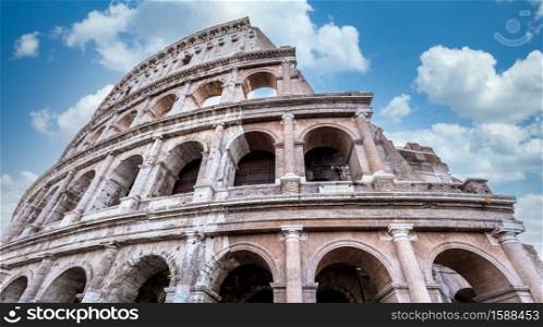 Detail of Colosseum in Rome (Roma), Italy. Also named Coliseum, this is the most famous Italian sightseeing. Spectacular blue sky in background.