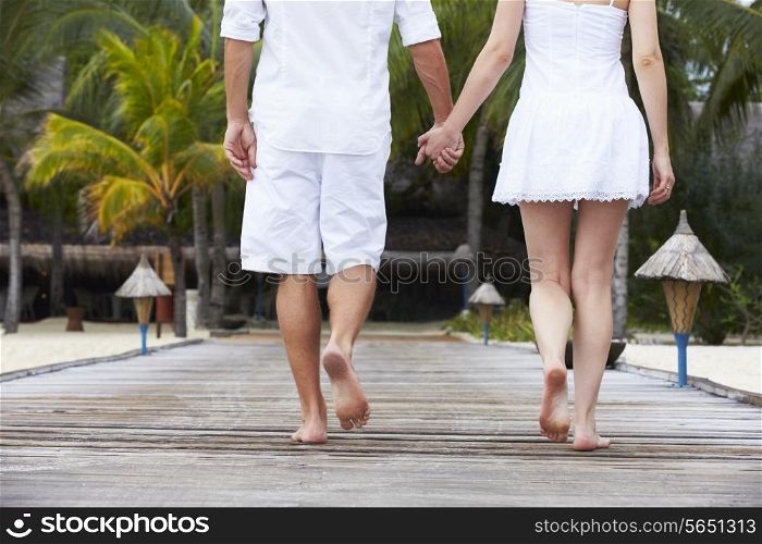 Detail Of Couple Walking On Wooden Jetty