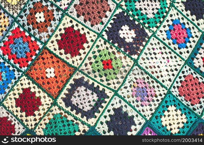 Detail of crocheted wool blanket with colorful checks