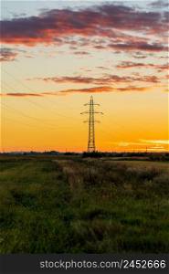 Detail of electric pole with electric cables and crop fields