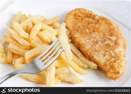 detail of fried potatoes and chicken with fork
