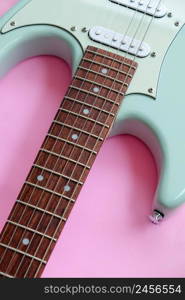 Detail of Mint Green Electric Guitar on a Pink background.