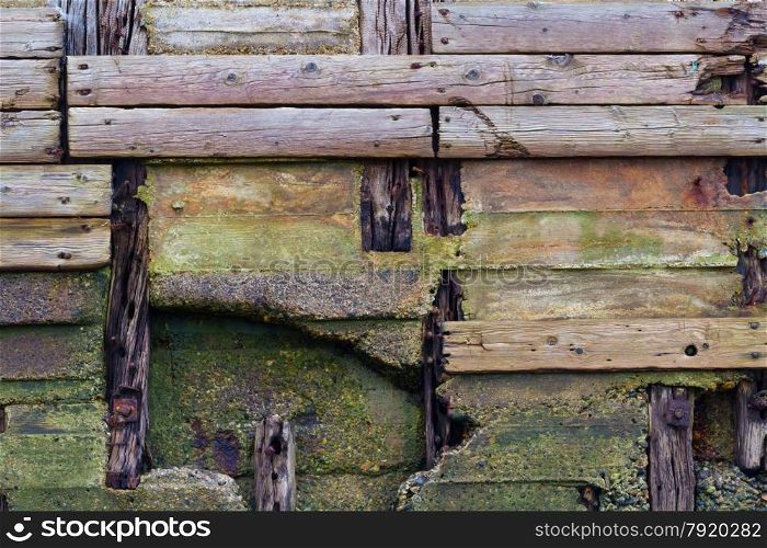 Detail of old pier, wooden planks weathered, crossing and decaying.