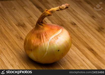 Detail of onion on wooden table