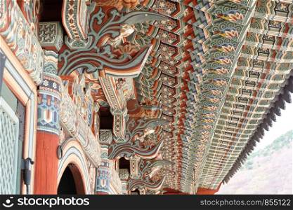 Detail of ornate on Korean Buddhist temple roof with design architectural elements at Beomeosa temple in Busan, South Korea