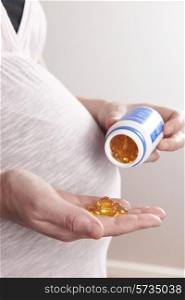 Detail Of Pregnant Woman Taking Vitamins