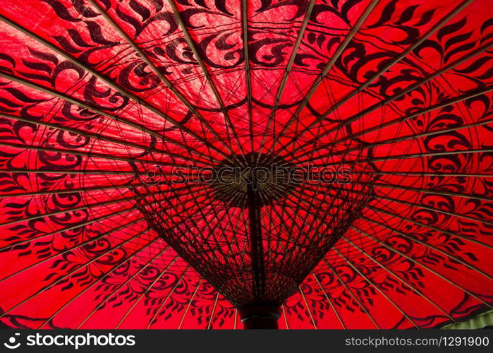 Detail of red parasol highlighted by the sun