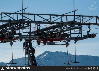 Detail of T-bar ski lift (drag lift) against great bkue sky