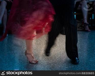 Detail of tango dancers in milonga ballroom