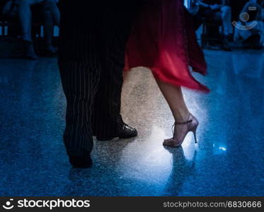 Detail of tango dancers in milonga ballroom