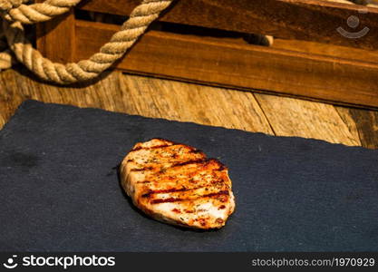 Detail of tasty pork steak on rustic background