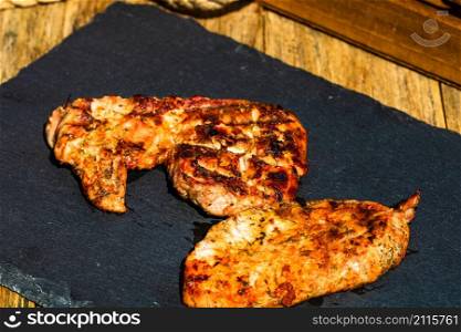 Detail of tasty pork steak on rustic background