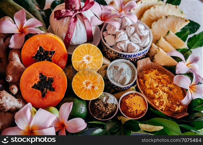 Detail of Thai spa ingredients with herbs and fresh tropical fruits, papaya, orange, ginger, turmeric and etc. close up top view shot
