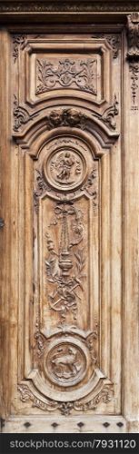 Detail of the beautiful carving work on the timber door of the cathedral of Grasse in France