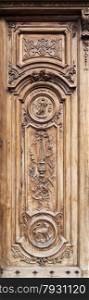 Detail of the beautiful carving work on the timber door of the cathedral of Grasse in France