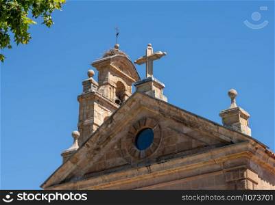 Detail of the bell tower and stork bird nest on the roof of San Pablo church in Salamanca Spain. Stork nest on bell tower of Church of San Pablo in Salamanca