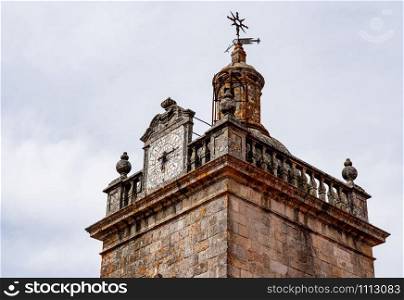 Detail of the clock and windvane on the the Se or cathedral church tower in the old town of Viseu. Detail of the clock on the towers of the Se or cathedral church in Viseu in Portugal
