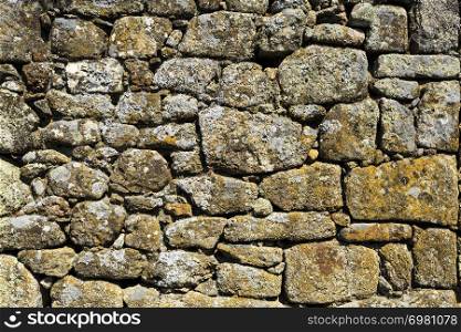 Detail of the construction with no mortar of a traditional local granite house of the rural architecture of the Beira Alta region in Portugal
