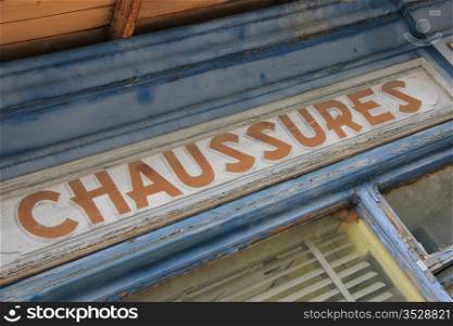 Detail of the facade of an old shoe shop in France