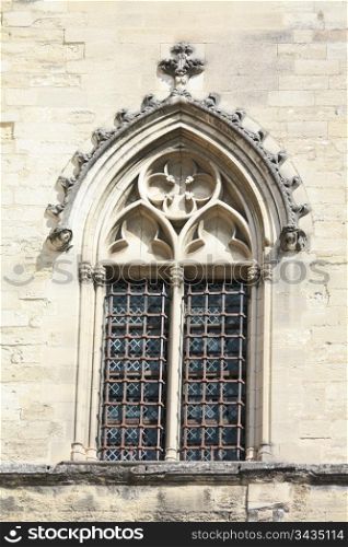 Detail of the facade of the Palais du Pape, ancient castle of the popes in Avignon, France, window with stained glass