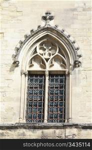 Detail of the facade of the Palais du Pape, ancient castle of the popes in Avignon, France, window with stained glass
