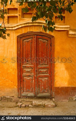 Detail of the Facade with Ancient Door and Leaves of Tree Above.. Vintage Door Image. Detail of the Facade with Ancient Door and Leaves of Tree Above. Image of Old Door.