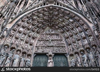 Detail of the fine sculpture above the main doors on the west facade of Strasbourg Cathedral in the city of Strasbourg in the Alsace region of France.