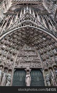 Detail of the fine sculpture above the main doors on the west facade of Strasbourg Cathedral in the city of Strasbourg in the Alsace region of France.