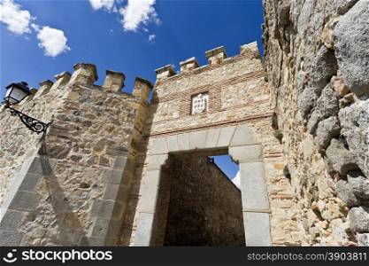 Detail of the gate seen from the side of the roman aqueduct in Segovia, Spain