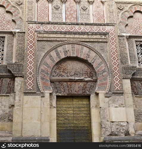 Detail of the Holy Spirit gate (Puerta del Espiritu Santo) on the west facade of the Mosque-Cathedral of Cordoba, Spain