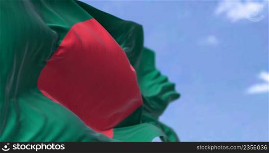 Detail of the national flag of Bangladesh waving in the wind on a clear day. is a country in South Asia. It is the eighth-most populous country in the world. Selective focus.