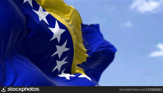 Detail of the national flag of Bosnia and Herzegovina waving in the wind on a clear day. Democracy and politics. Selective focus. Bosnia, is a country at the crossroads of south and southeast Europe