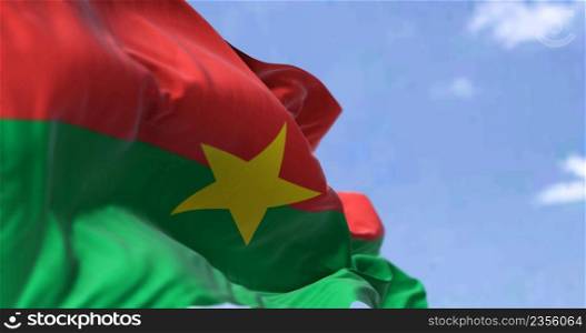 Detail of the national flag of Burkina Faso waving in the wind on a clear day. Democracy and politics. Patriotism. Selective focus. Burkina Faso is a landlocked country in West Africa