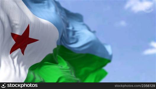 Detail of the national flag of Djibouti waving in the wind on a clear day. Djibouti is a country located in the Horn of Africa. Selective focus.