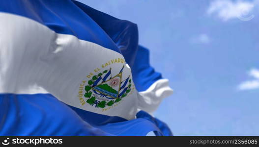 Detail of the national flag of El Salvador waving in the wind on a clear day. El Salvador is a country in Central America. Selective focus.
