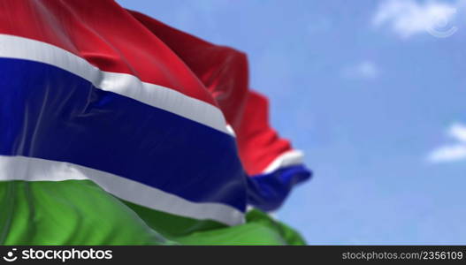 Detail of the national flag of Gambia waving in the wind on a clear day. Gambiac iis a country in West Africa. Selective focus. Seamless slow motion